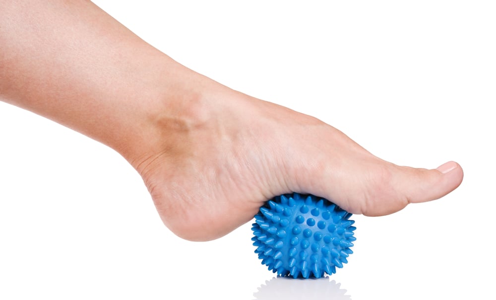 Foot rolls on a ball can ease tension throughout your body all the way up to your brain. 