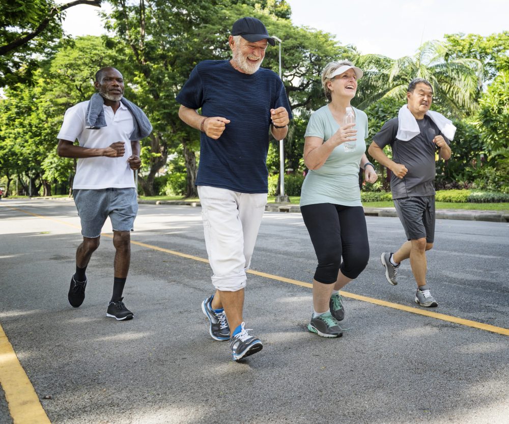 group of four healthy seniors exercising