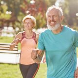 Active, mature man and woman exercising