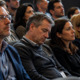Common Nutrient Deficiency Symptoms and Warning Signs Man struggling to stay awake during a seminar while others listen attentively