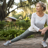 Woman performing a side stretch outdoors to help support comfortable movement